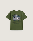 An olive green Vans t-shirt with a graphic print of a dog in a dumpster and the text 'CALL: (555)-HAUL-JUNK' on a light beige background.