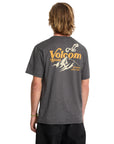 Person wearing a gray Volcom t-shirt with a mountain graphic on the back.