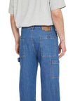 Person wearing blue jeans with a white background