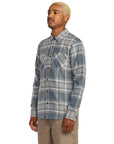 Man wearing a Volcom plaid shirt on a white background - available at Mango Surfing.