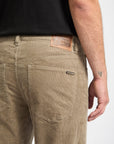 Brown pants with a visible brand label on a white background