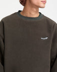 Brown sweatshirt with a small white logo on a neutral background