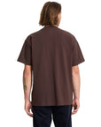 Person wearing a brown t-shirt on a white background