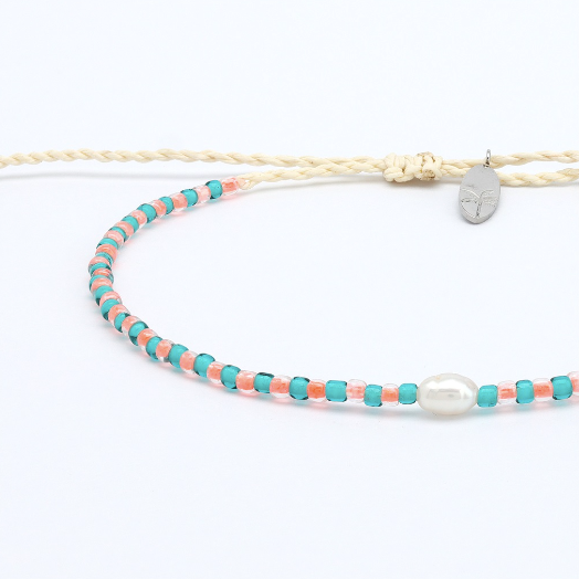 A delicate double-strand necklace featuring a cream-colored braided cord with a small silver pendant, alongside a beaded strand of turquoise and coral beads with a white pearl accent, displayed on a clean white background.