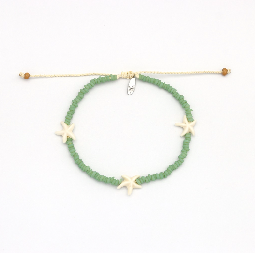 A beaded bracelet with green round beads, three cream starfish charms, and a cream adjustable cord closure with small brown beads at the ends, shown on a white background.