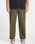 Person wearing olive green Volcom cargo pants on a white background