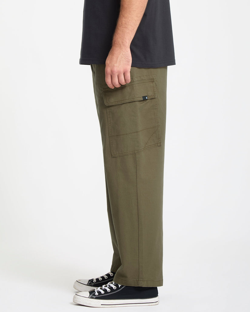 Person wearing olive green cargo pants on a white background