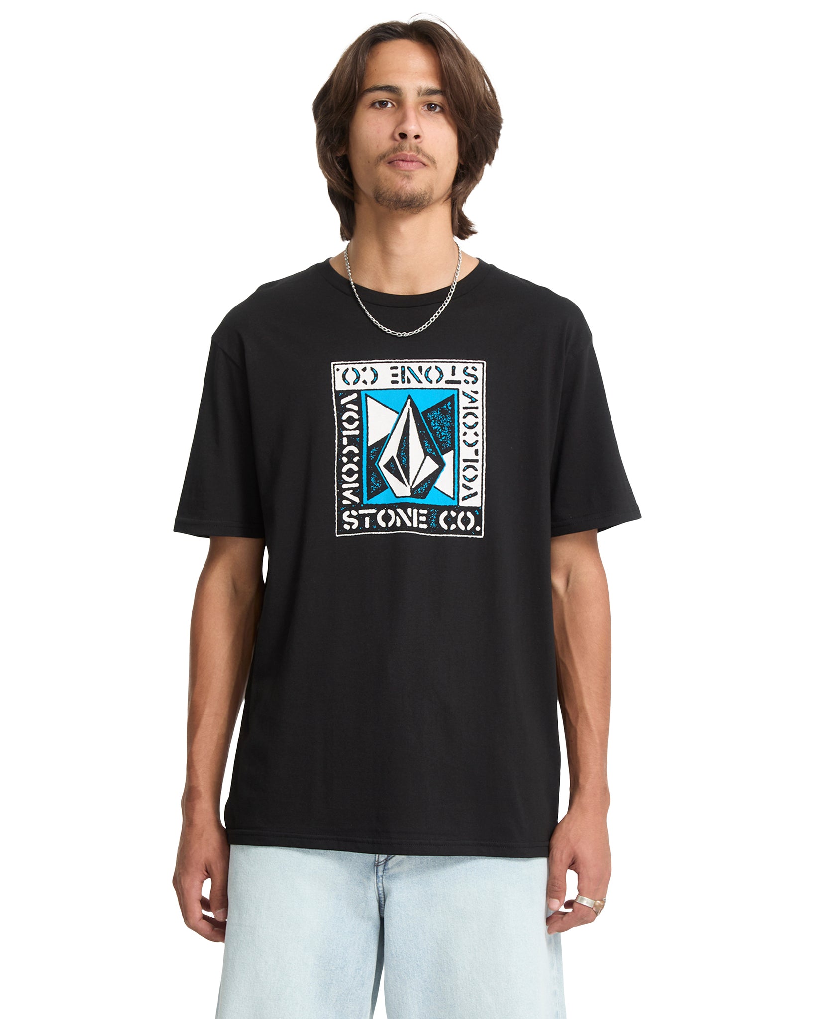 Person wearing a black Volcom t-shirt with a logo on a white background