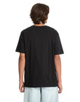 Person wearing a black Volcom  t-shirt on a white background