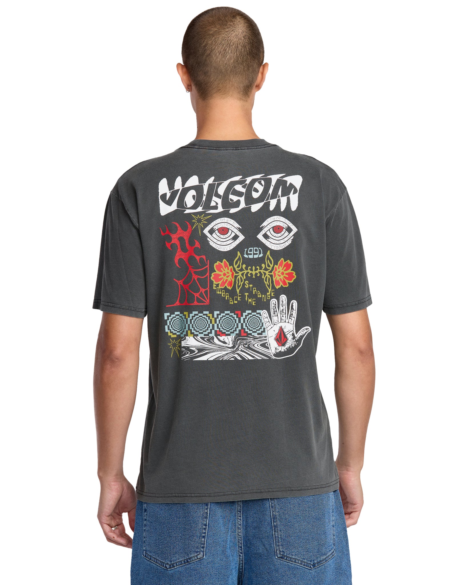 Person wearing a dark gray t-shirt with colorful designs on the back, on a white background