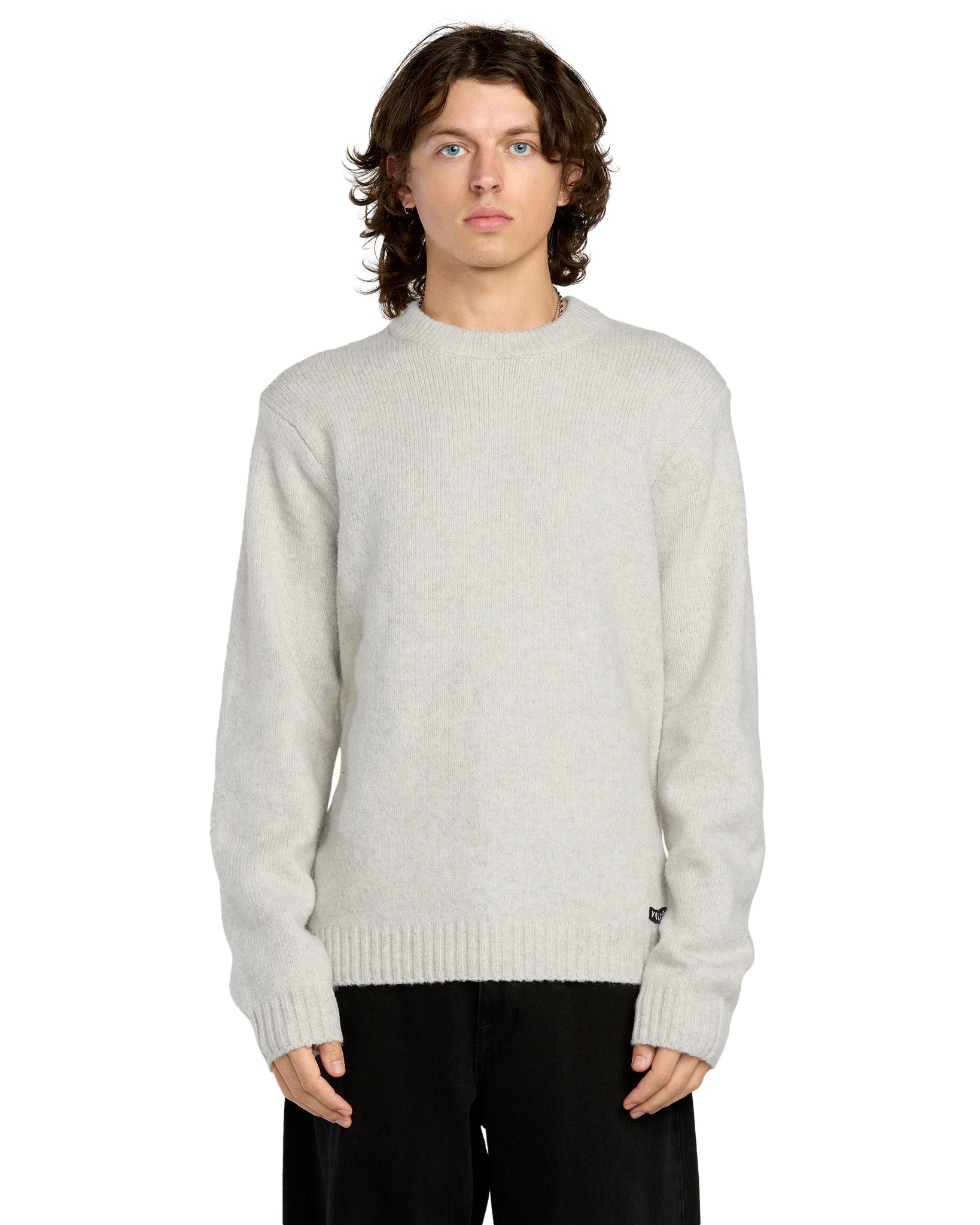 Person wearing a light gray sweater on a white background