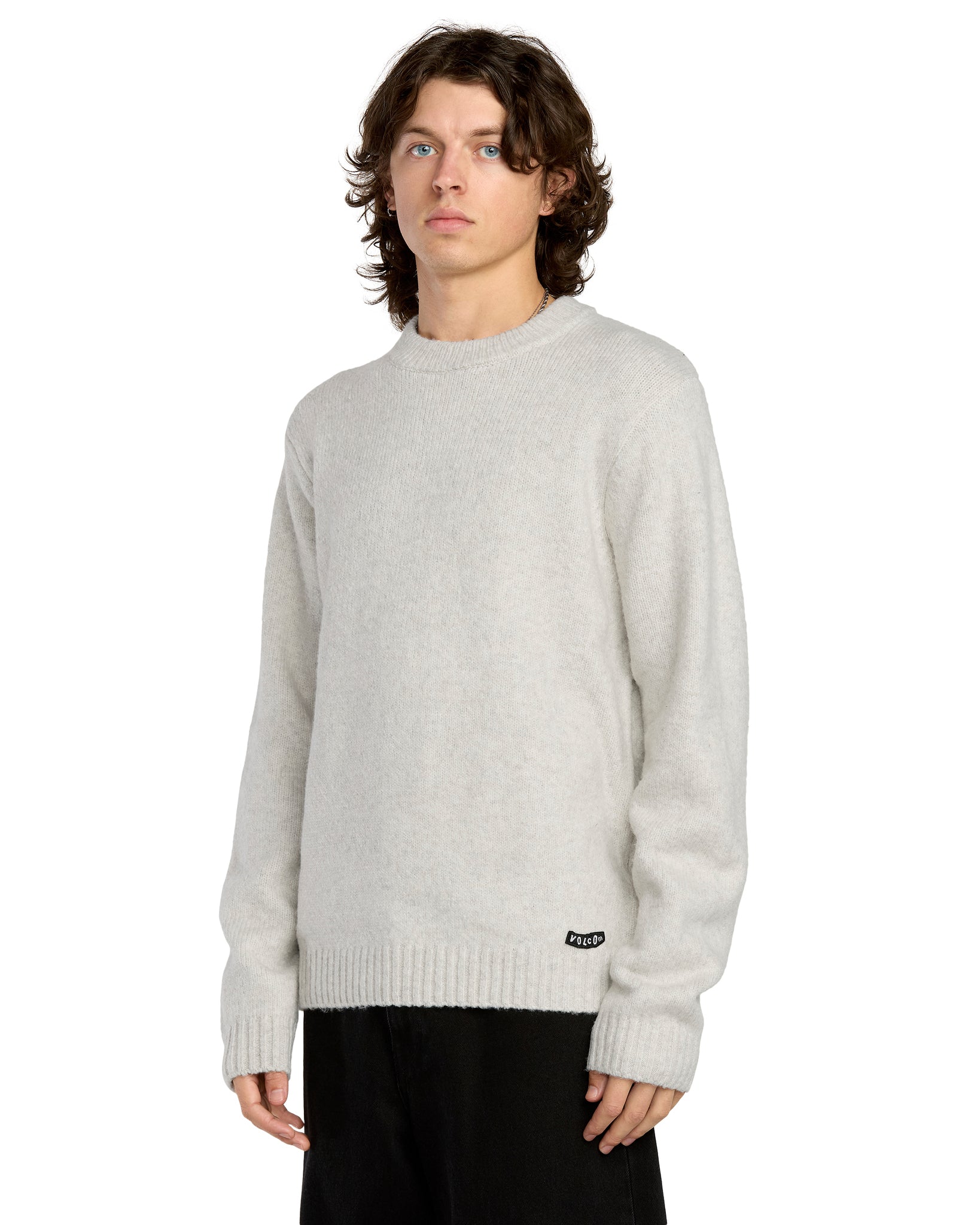 Person wearing a light gray sweater on a white background