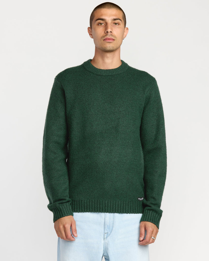 Man wearing a green sweater on a white background