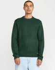 Man wearing a green sweater on a white background