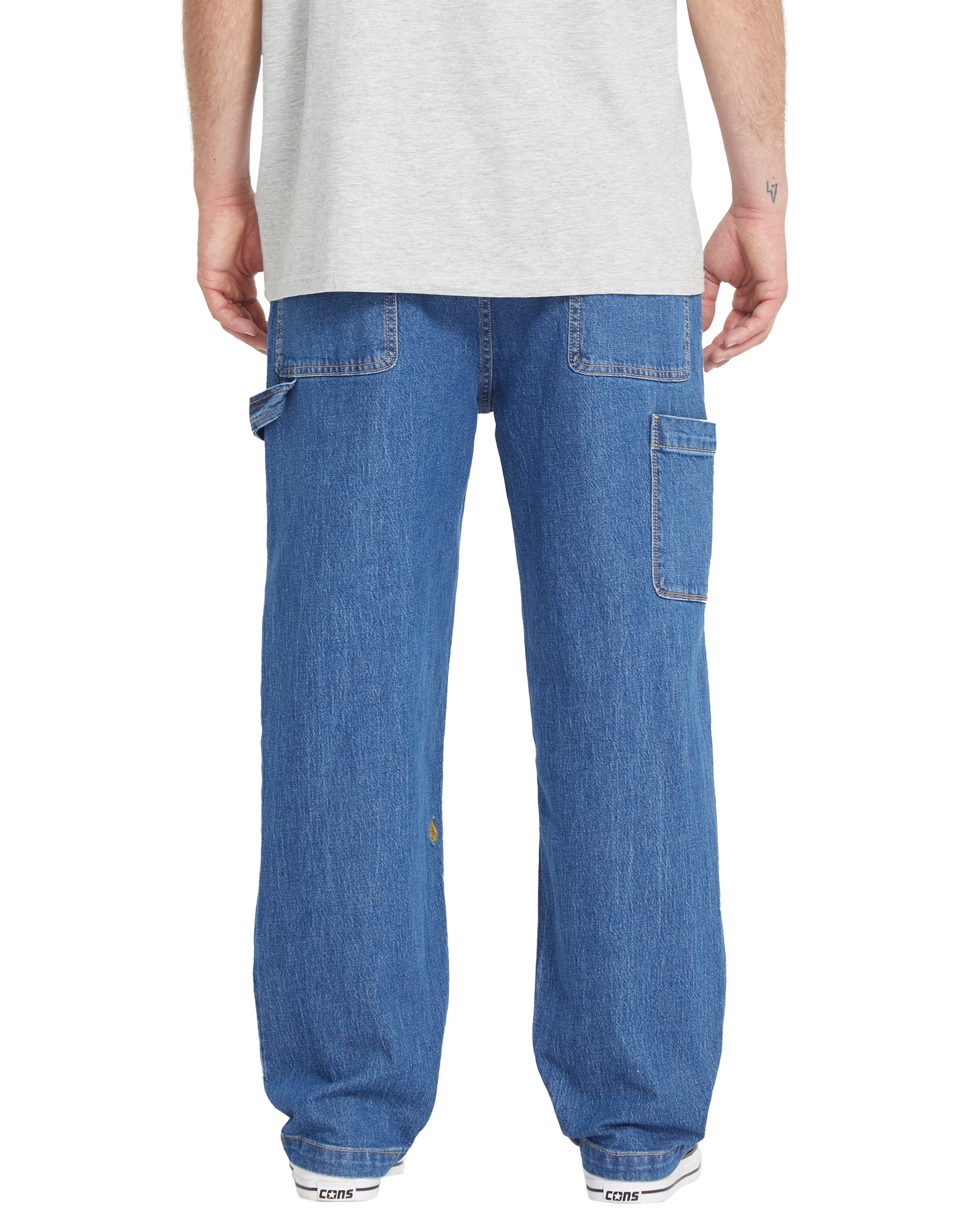 Person wearing blue jeans on a white background