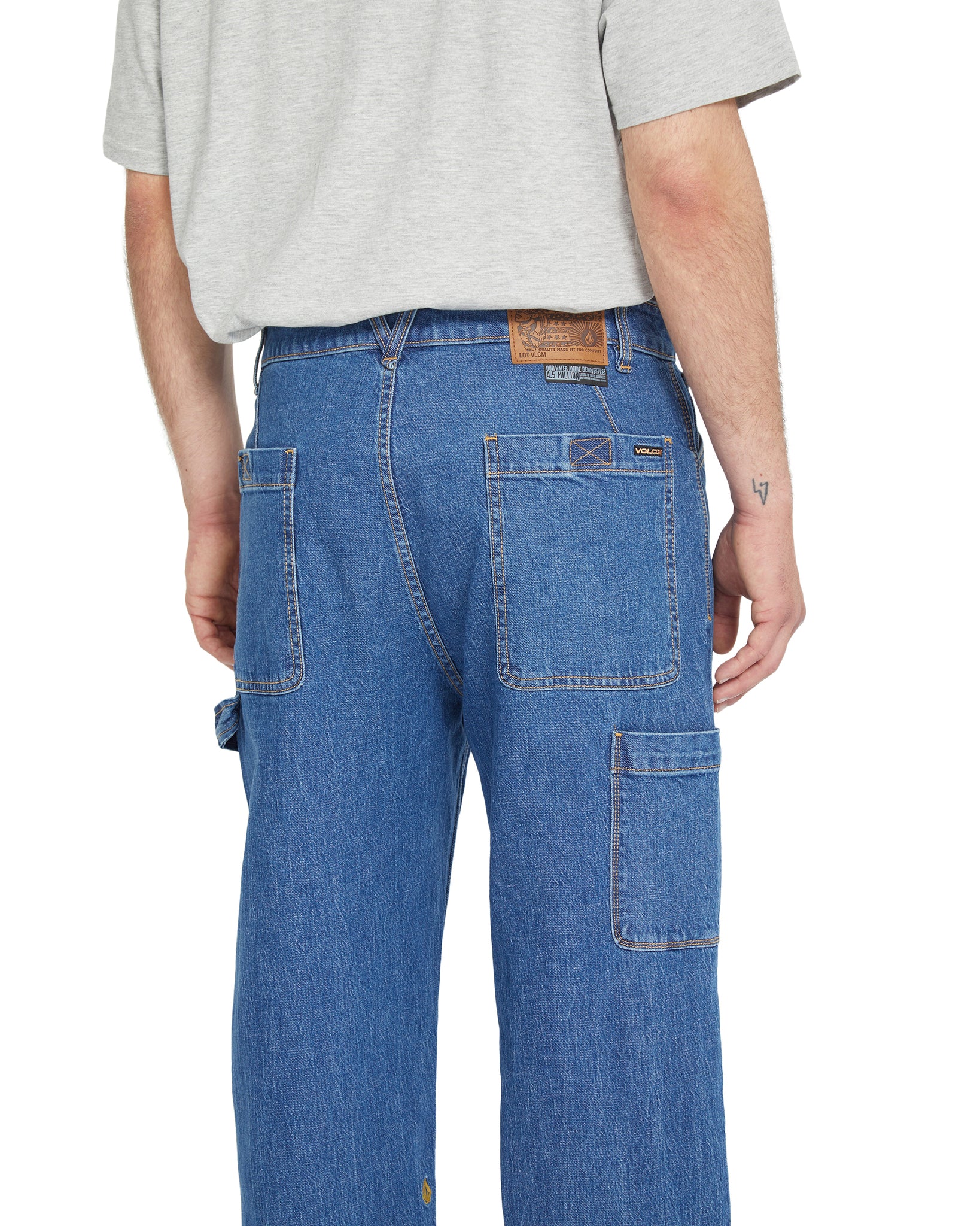Person wearing blue jeans with a white background