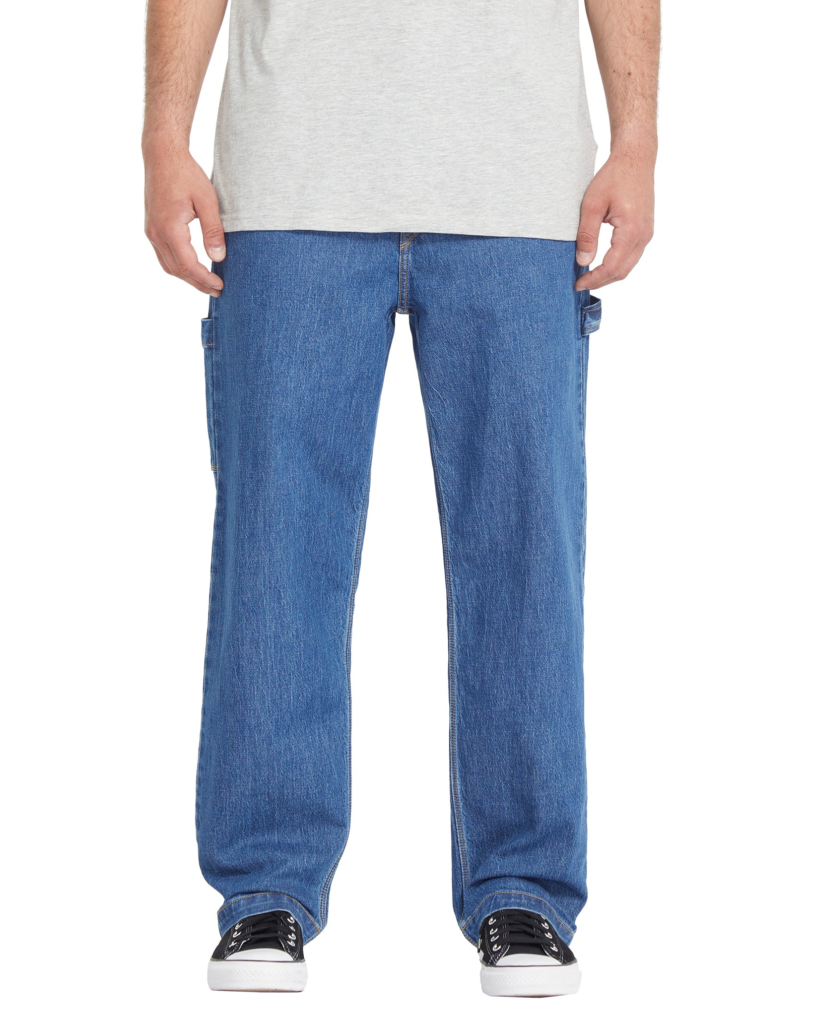 Person wearing blue jeans and a white shirt on a white background