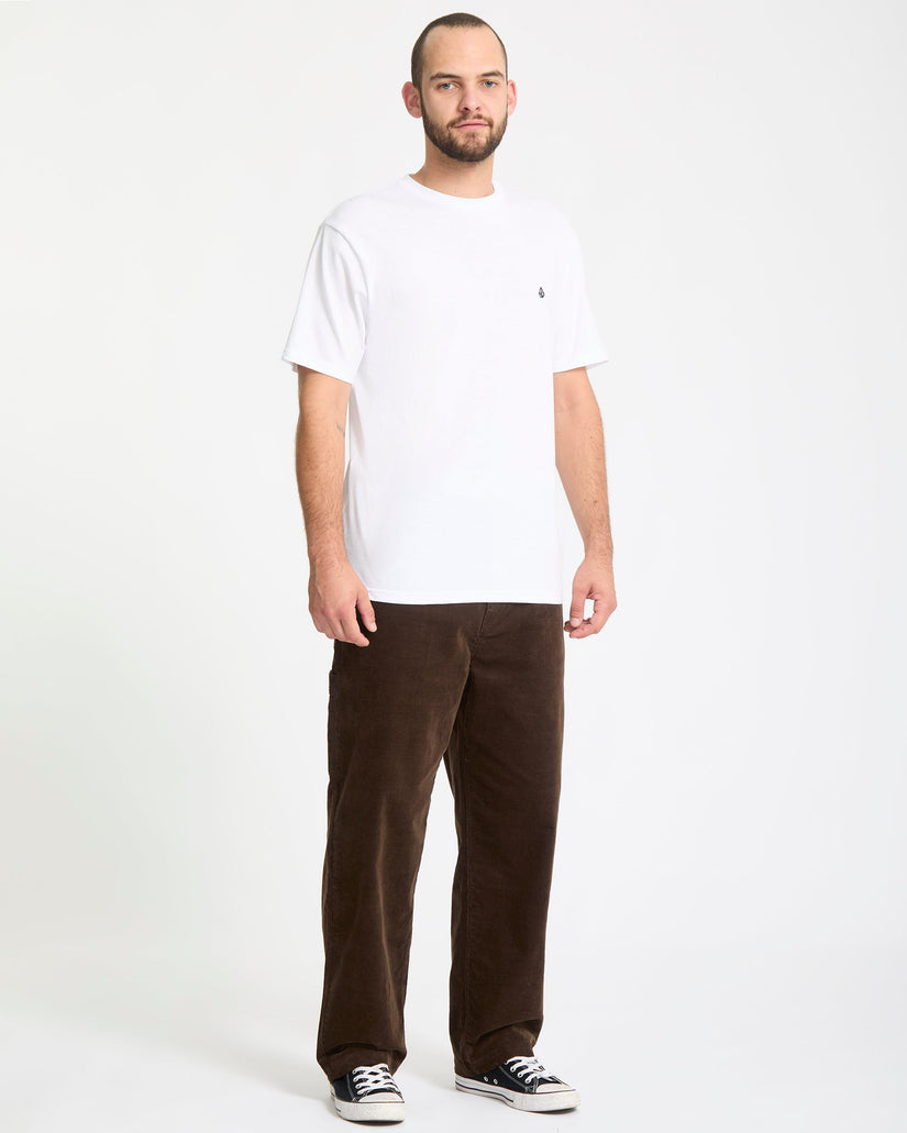 Man wearing a white t-shirt and brown pants on a white background