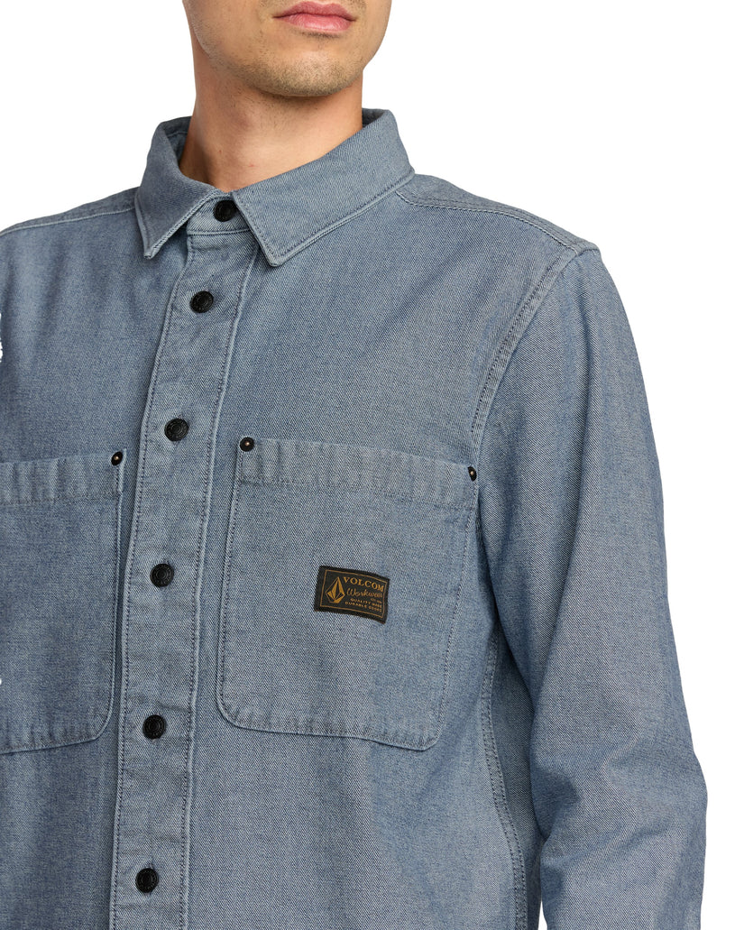 Blue denim Volcom shirt with a brand logo on a white background - available at Mango Surfing.