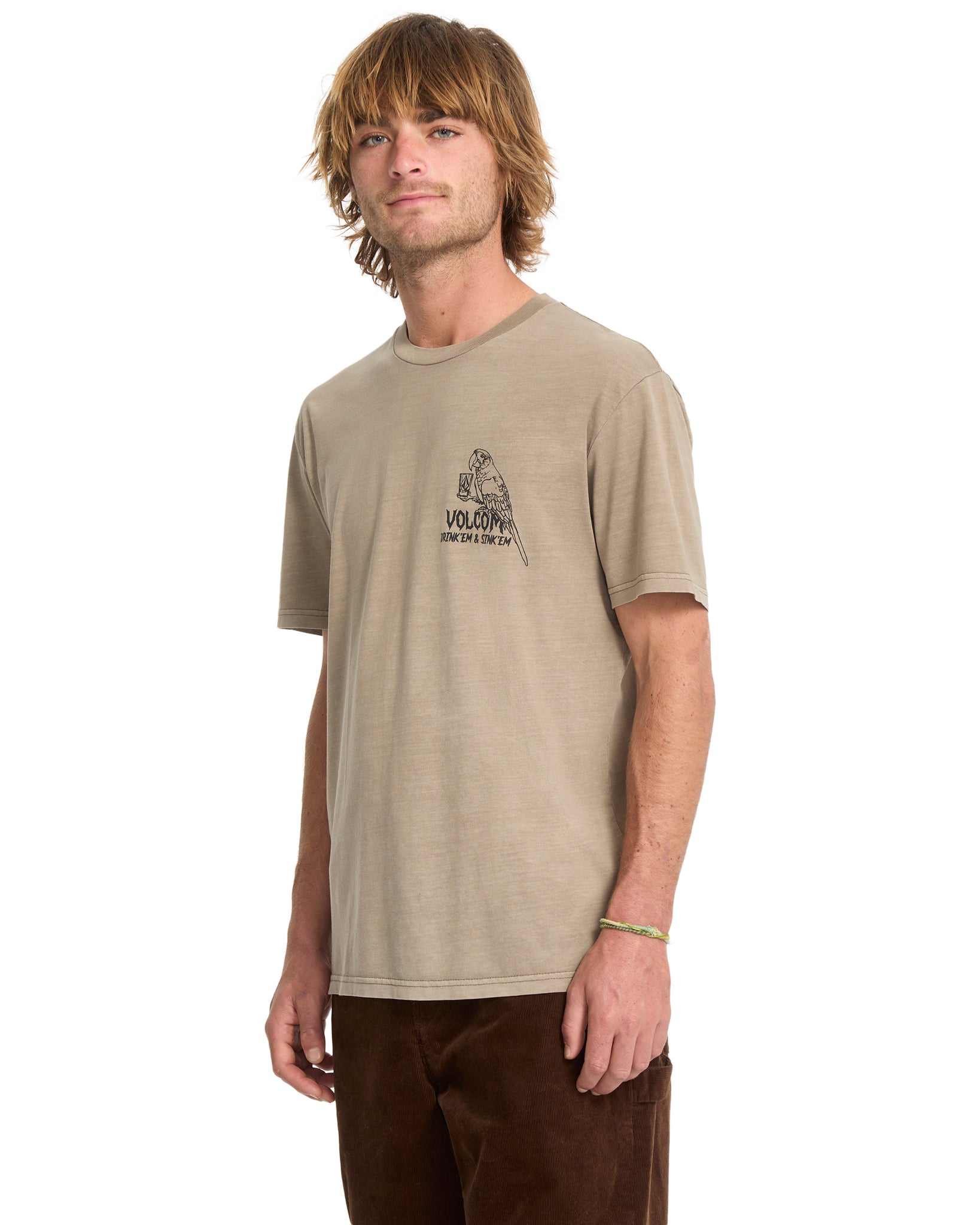 Man wearing a beige t-shirt with a logo on a white background