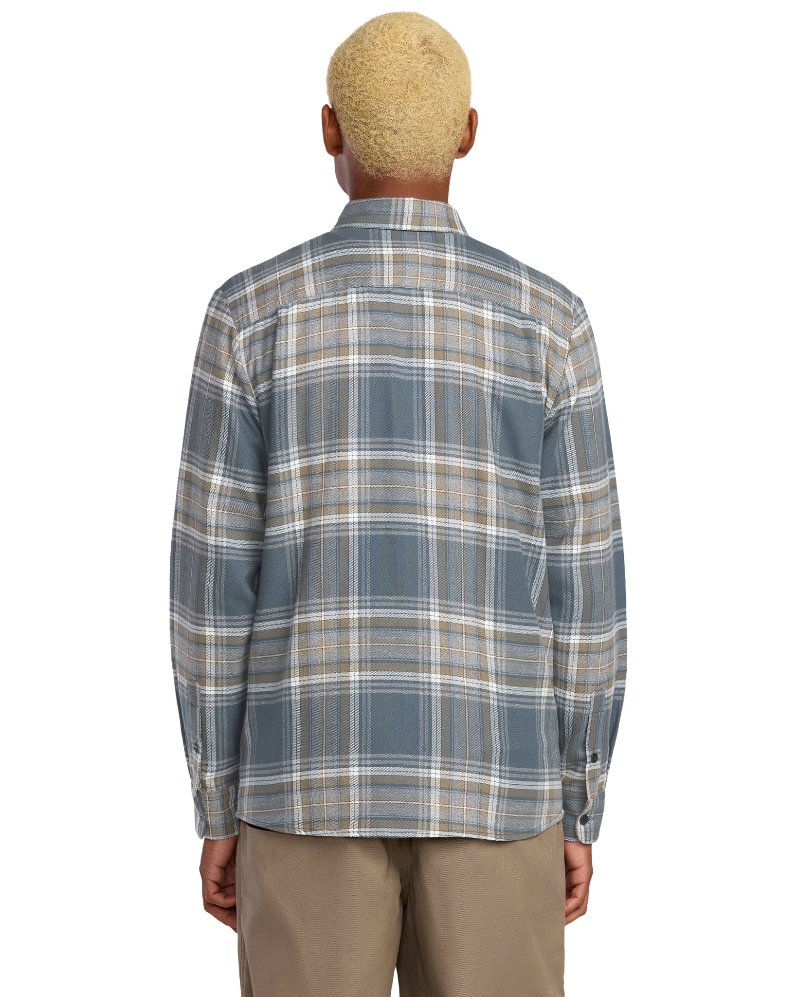 Person wearing a Volcom plaid shirt on a white background, available to buy at Mango Surfing.