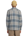 Person wearing a Volcom plaid shirt on a white background, available to buy at Mango Surfing.