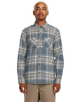 Man wearing a Volcom plaid shirt on a white background, available at Mango Surfing.