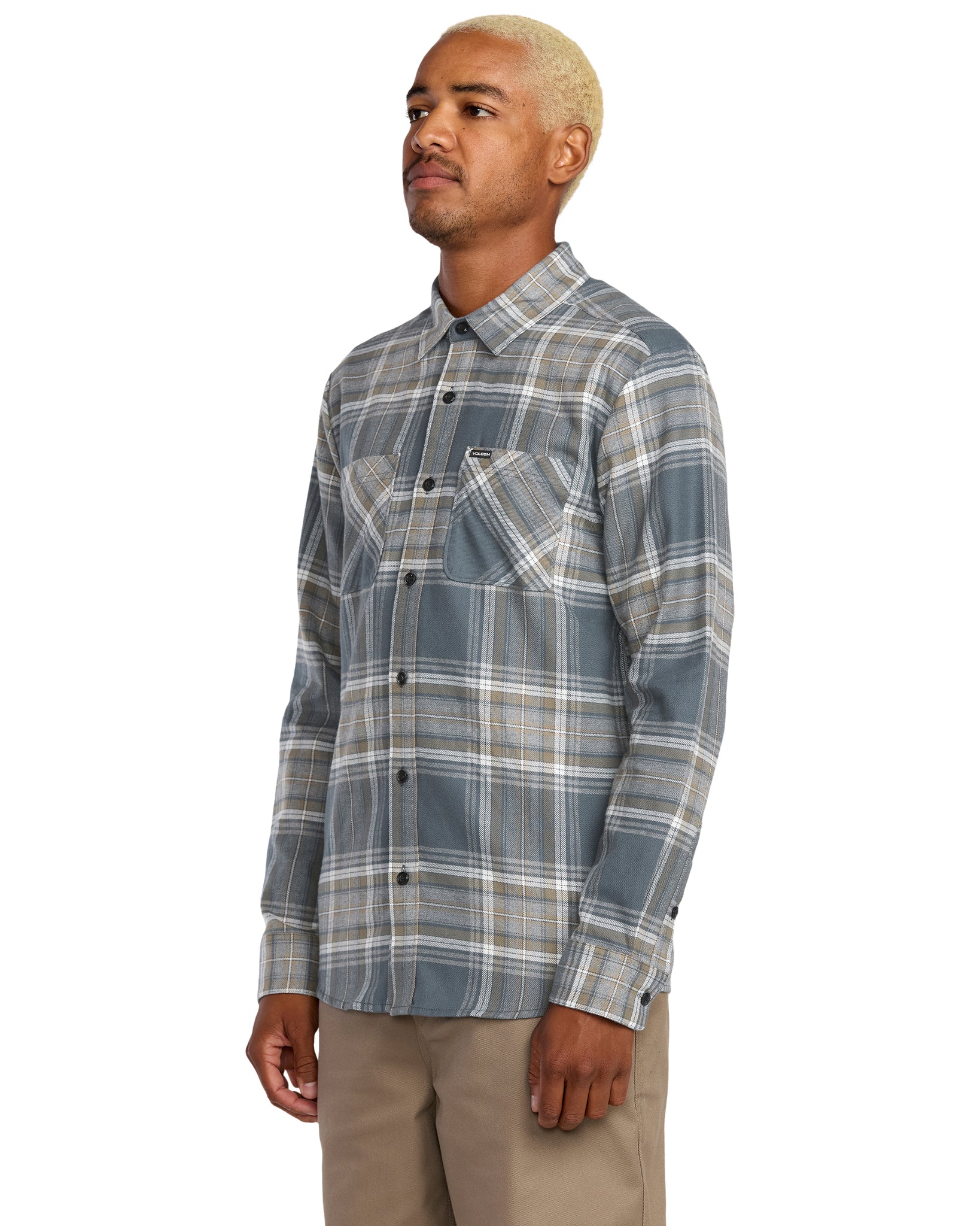 Man wearing a Volcom plaid shirt on a white background - available at Mango Surfing.