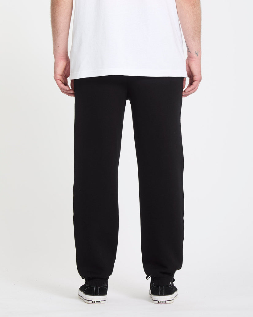 Person wearing black pants and a white shirt on a white background
