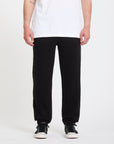 Person wearing black pants and a white shirt on a white background