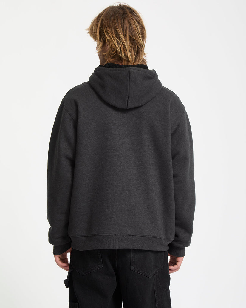 Person wearing a dark gray hoodie on a white background