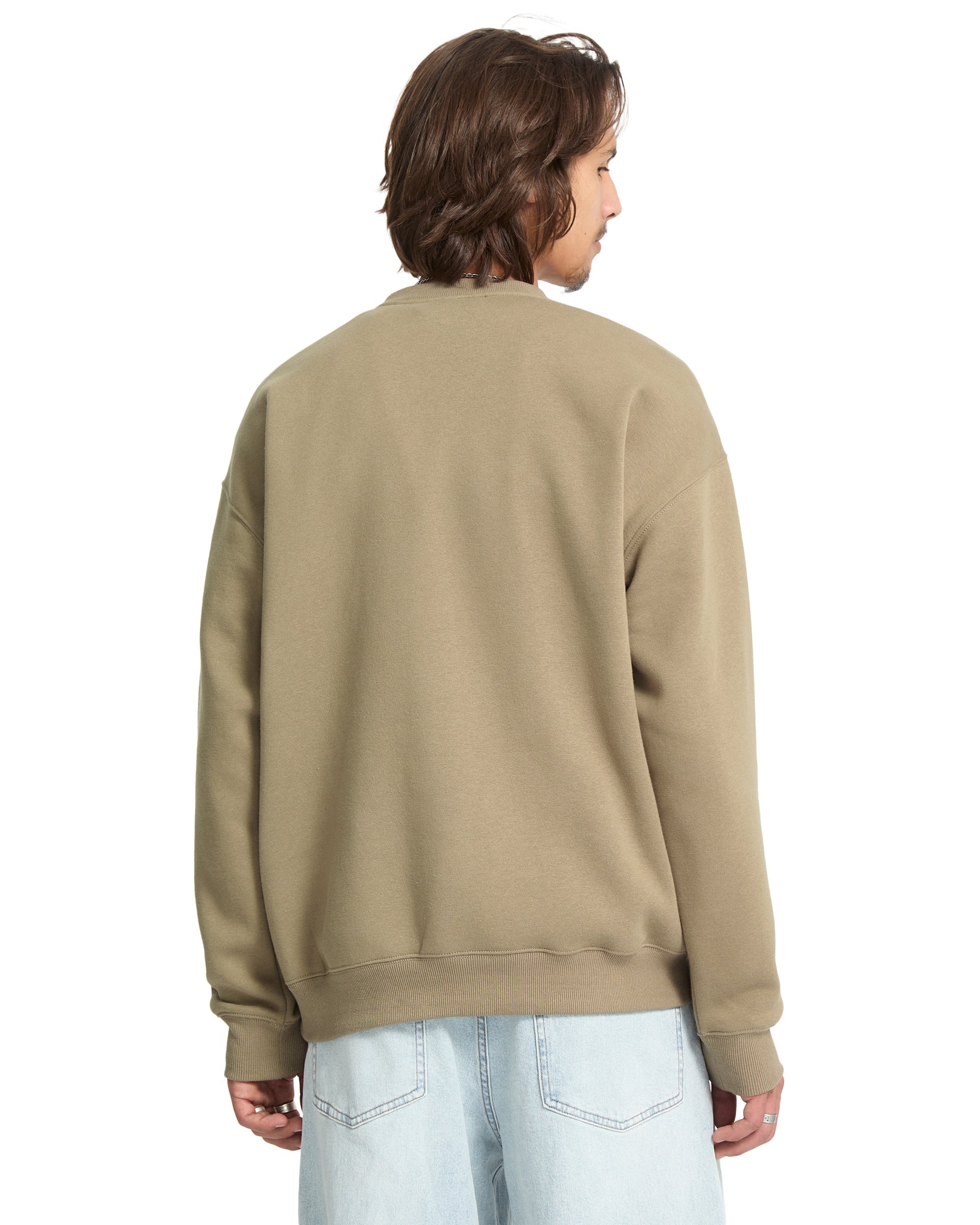 Person wearing a beige sweatshirt on a white background