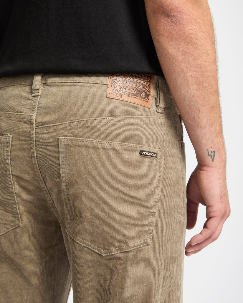 Brown pants with a visible brand label on a white background