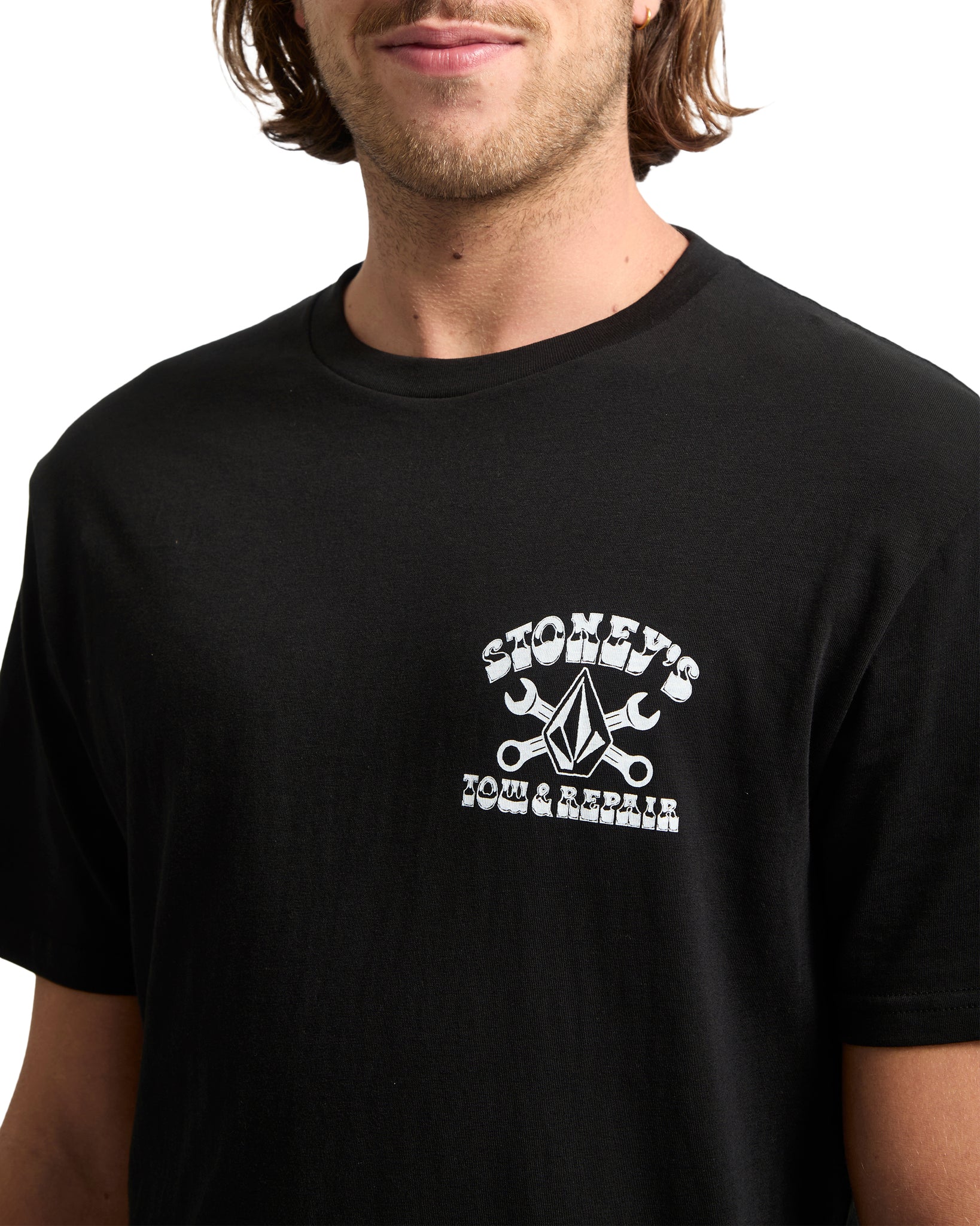 Person wearing a black t-shirt with a white graphic design on a white background