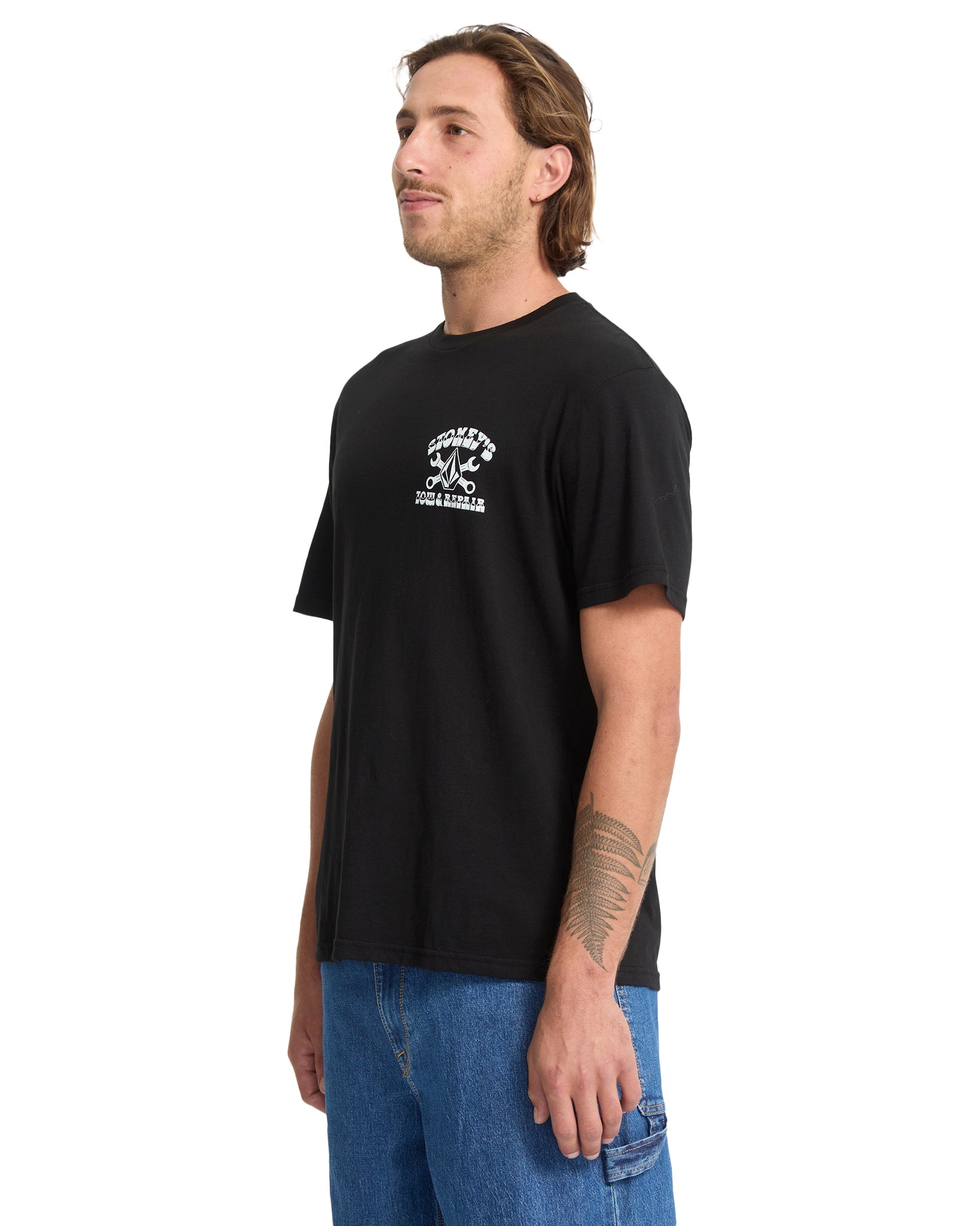 Man wearing a black t-shirt with a logo on a white background