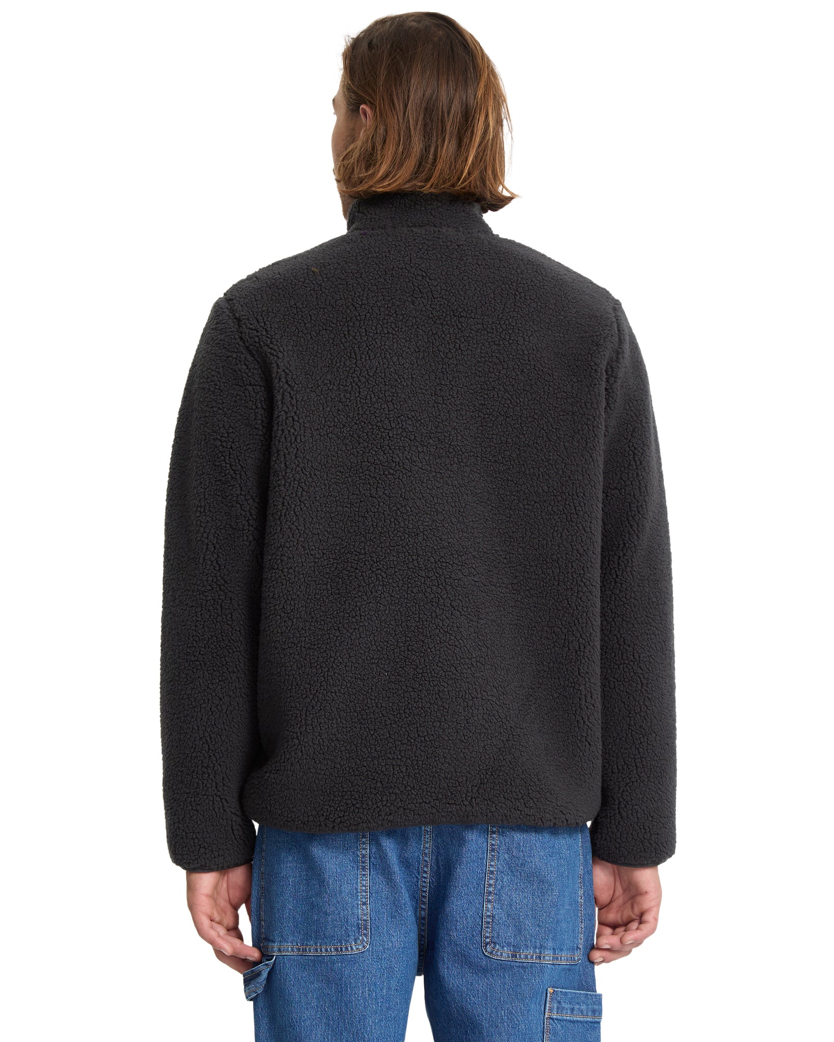 Person wearing a dark gray fleece jacket on a white background