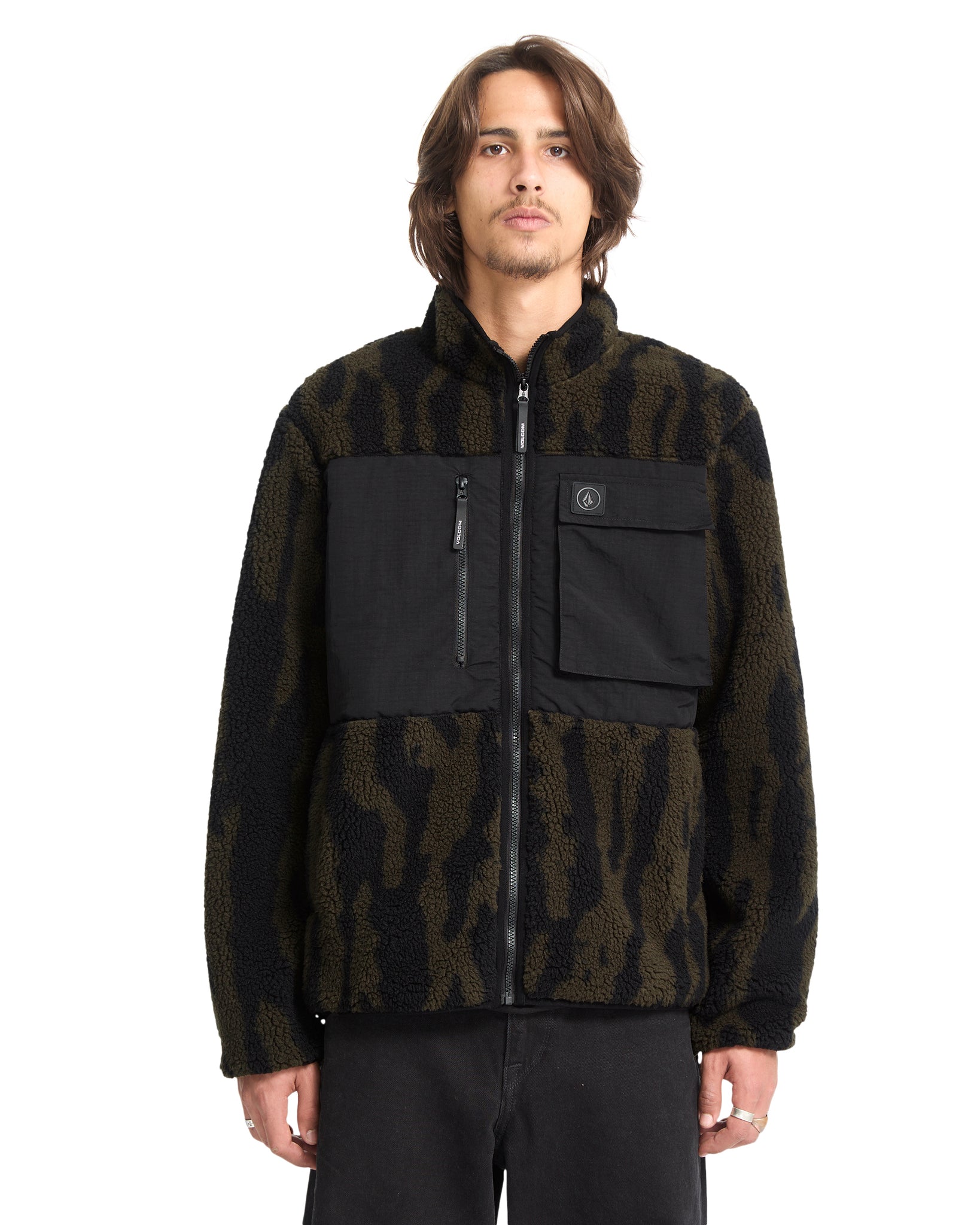 Man wearing a black and brown patterned jacket on a white background