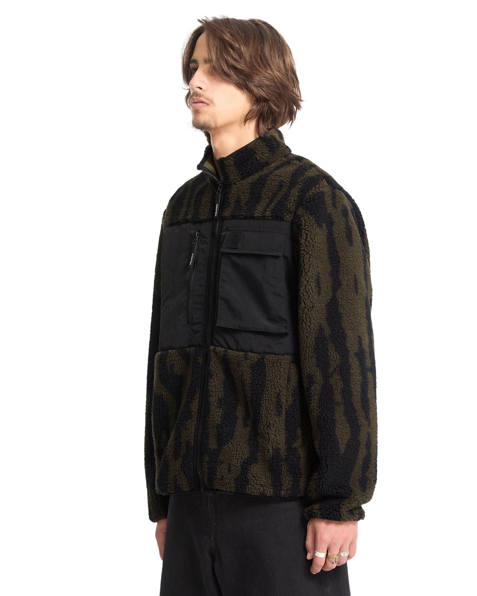 Man wearing a dark patterned jacket with a white background