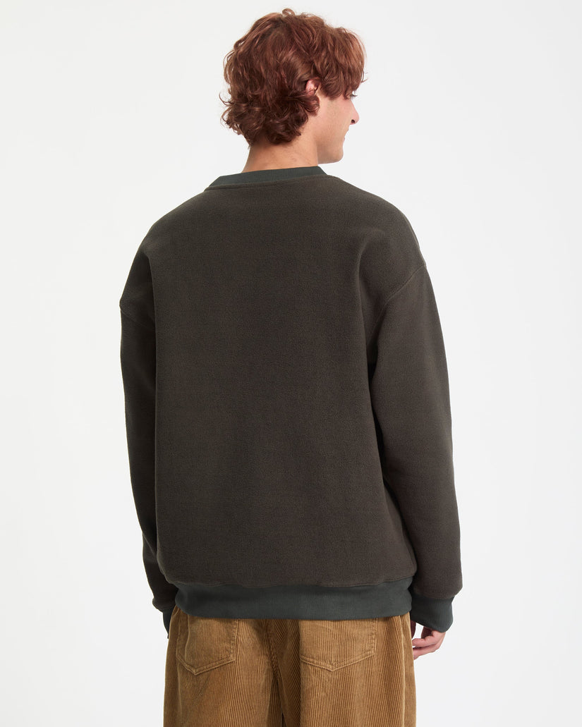Person wearing a dark green sweatshirt on a white background