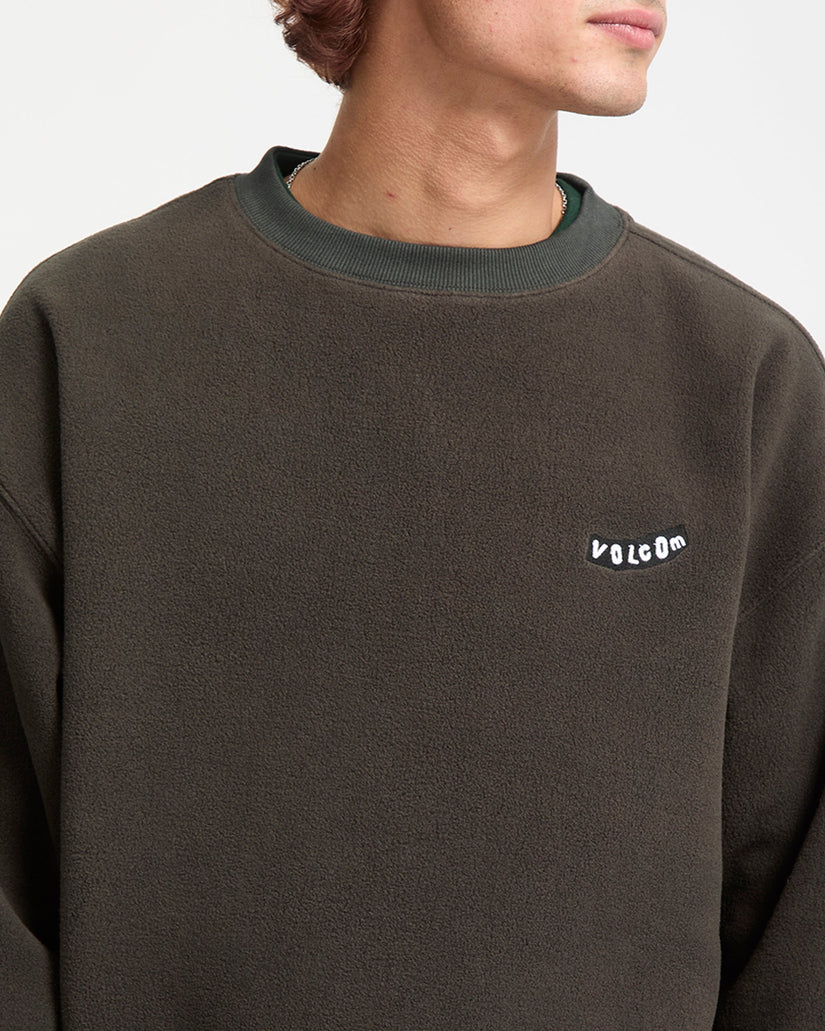 Brown sweatshirt with a small white logo on a neutral background