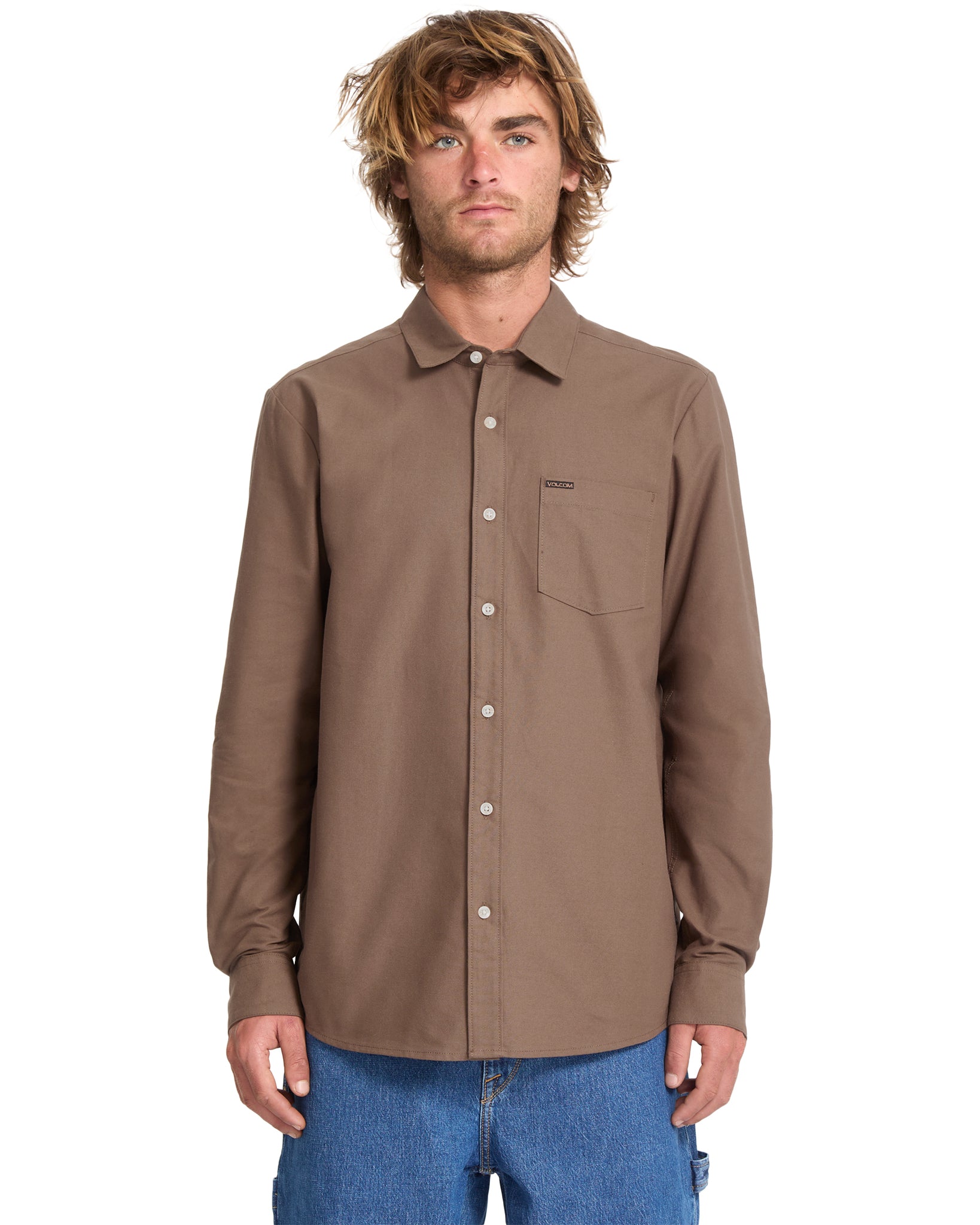 Man wearing a brown button-up shirt with a pocket on a white background