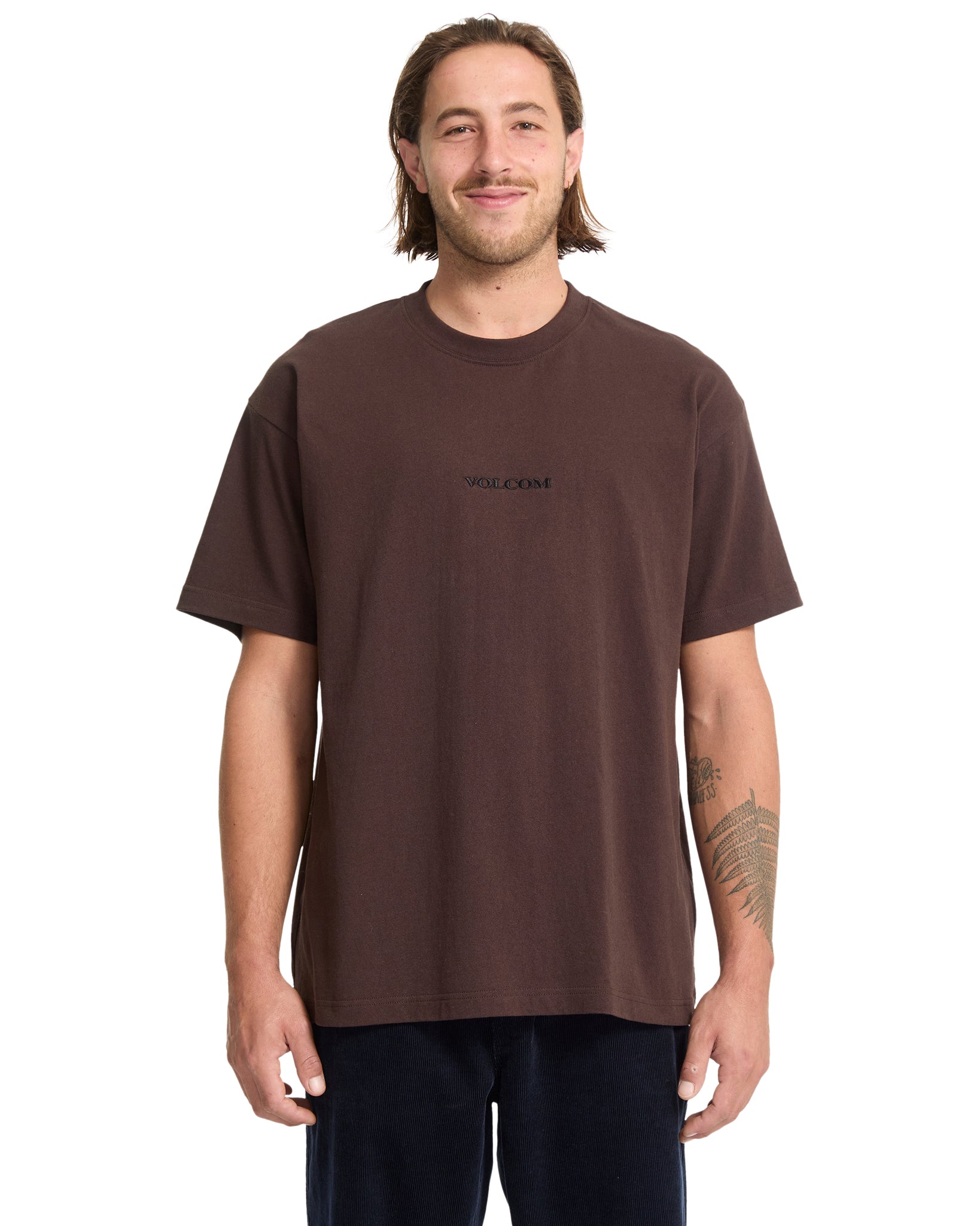 Man wearing a brown t-shirt with a logo on a white background