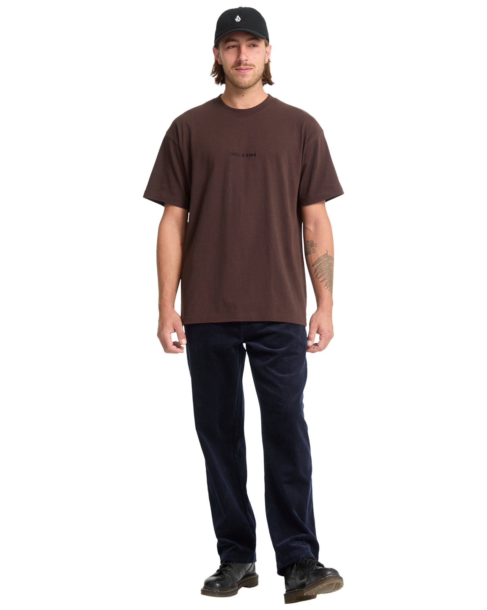 Man wearing a brown t-shirt and black cap on a white background