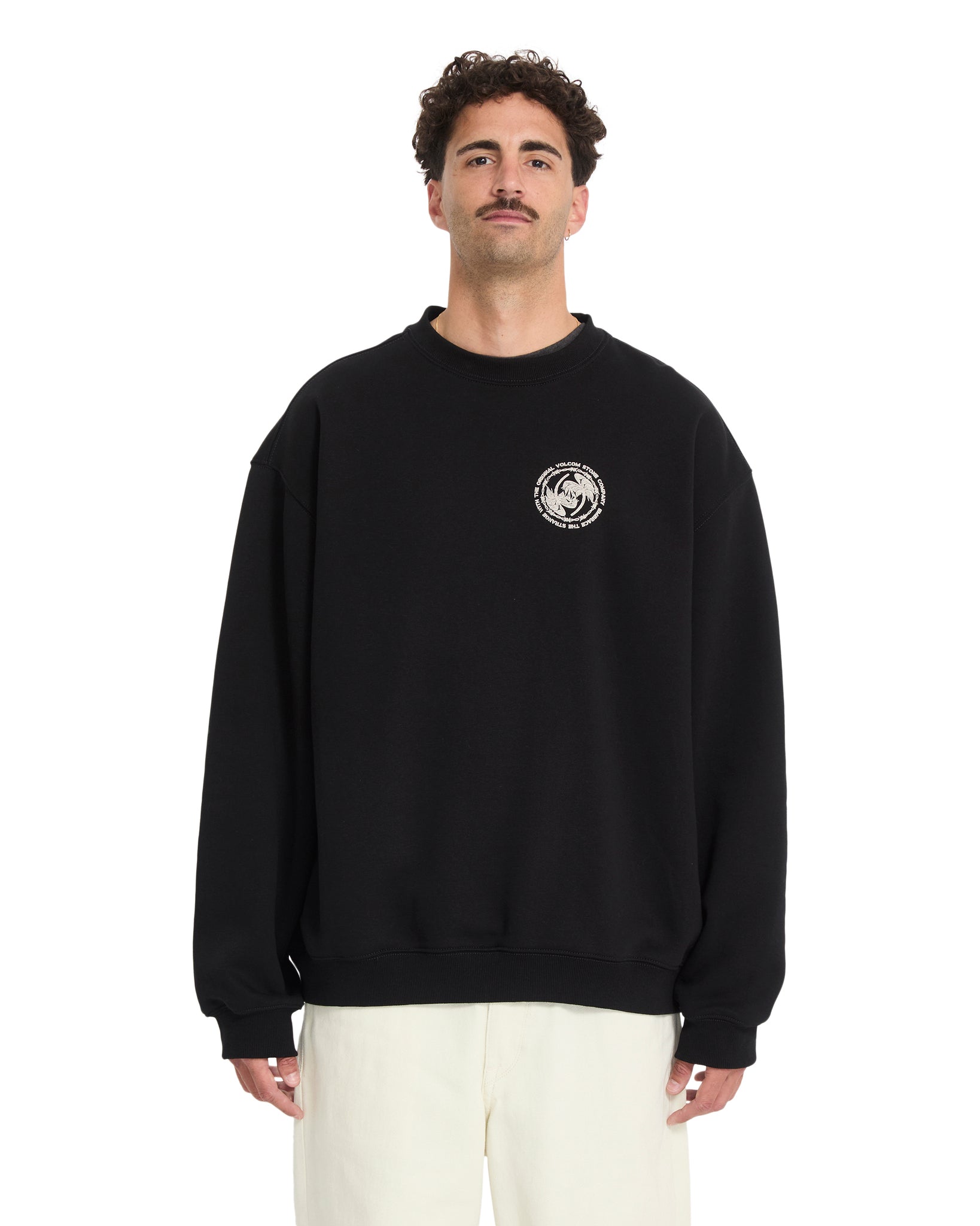 Man wearing a black sweatshirt with a logo on a white background