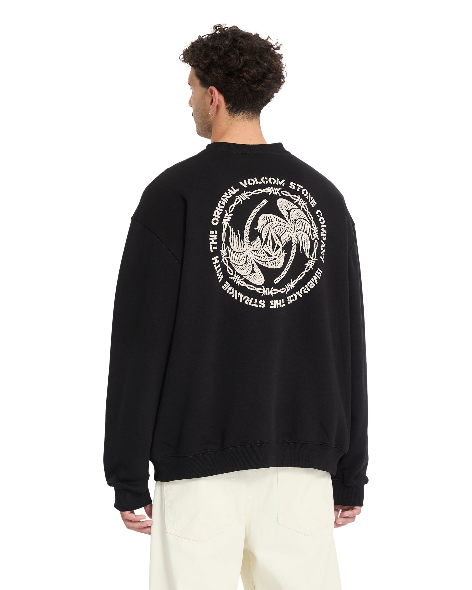 Person wearing a black sweatshirt with a white graphic design on the back, standing against a white background.