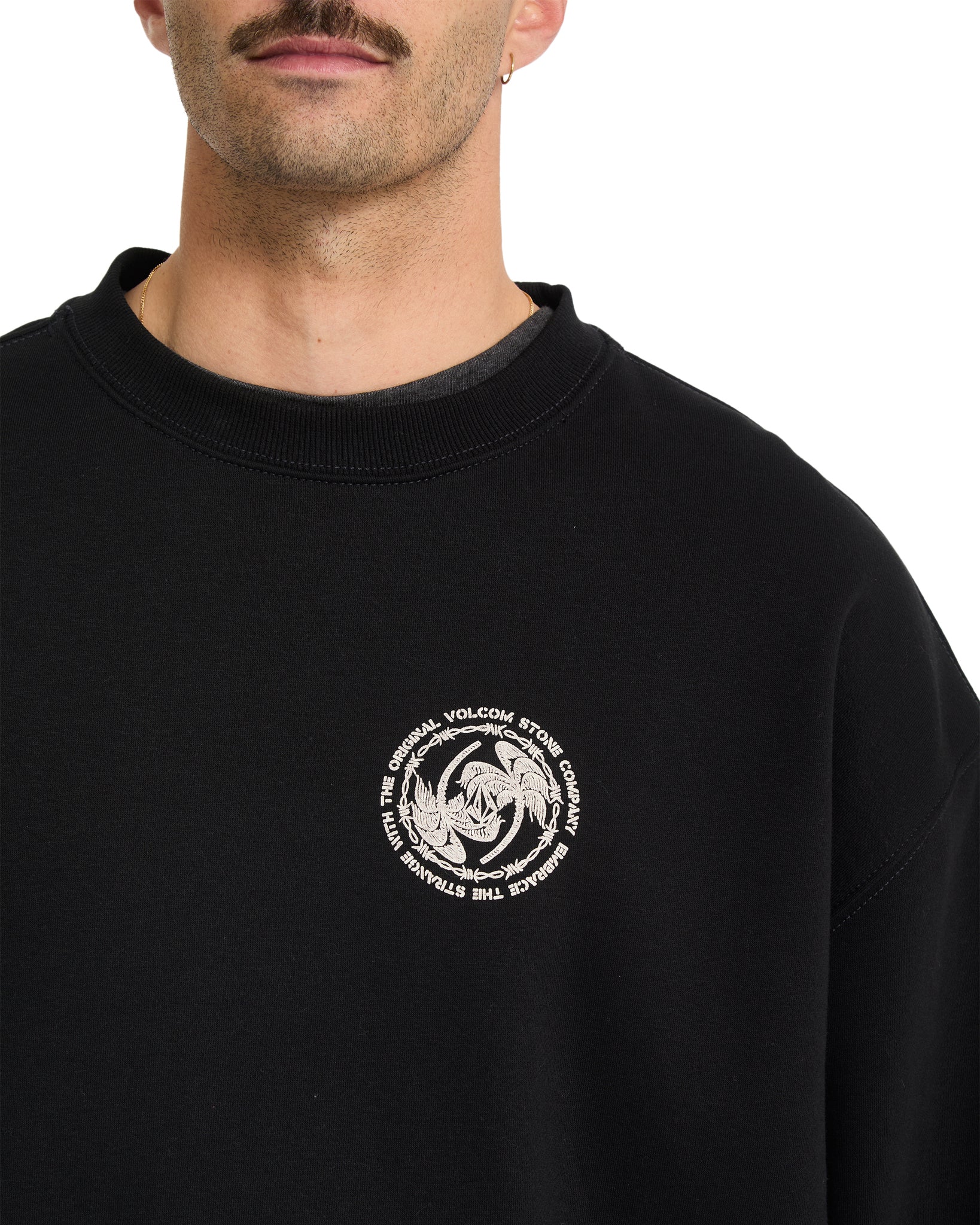 Black sweatshirt with a white Volcom logo on a white background